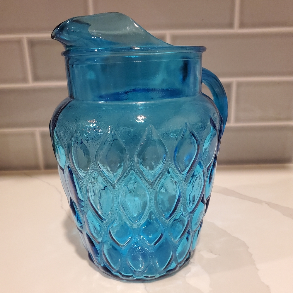Vintage aqua blue pitcher, approximately 9 inches tall
